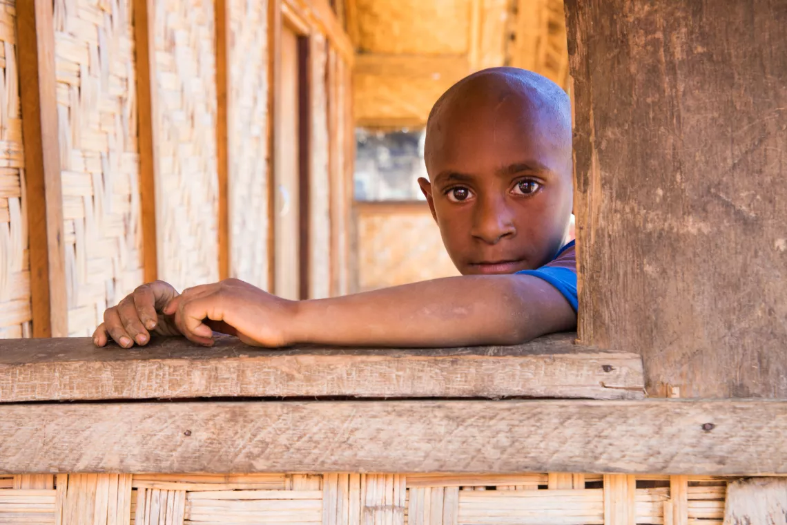 Papua New Guinea. A boy sits by the window of a clinic.